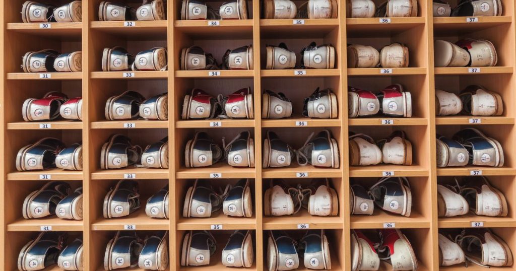 Bowling shoes on a wooden shelf