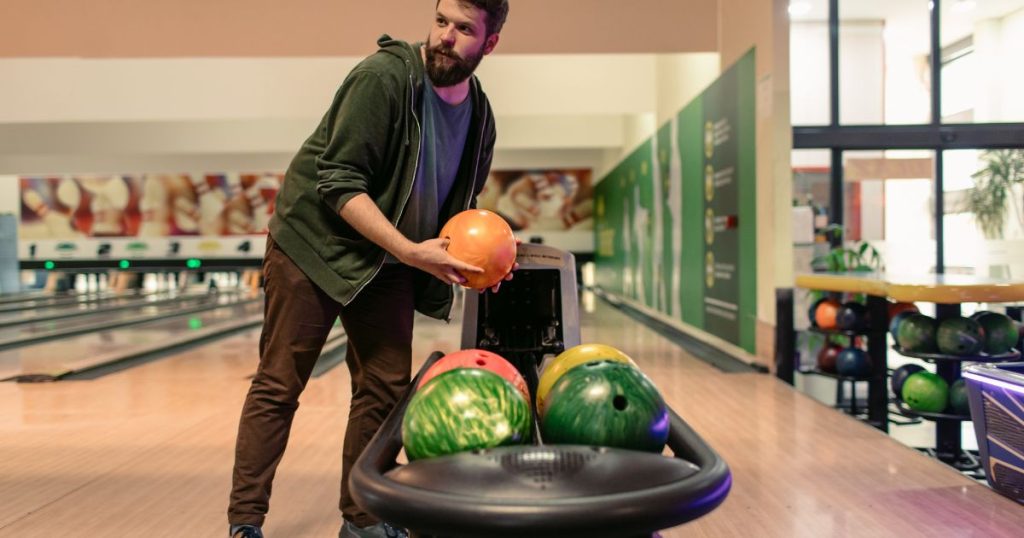 Man Taking His Time to Choose The Right Bowling Ball